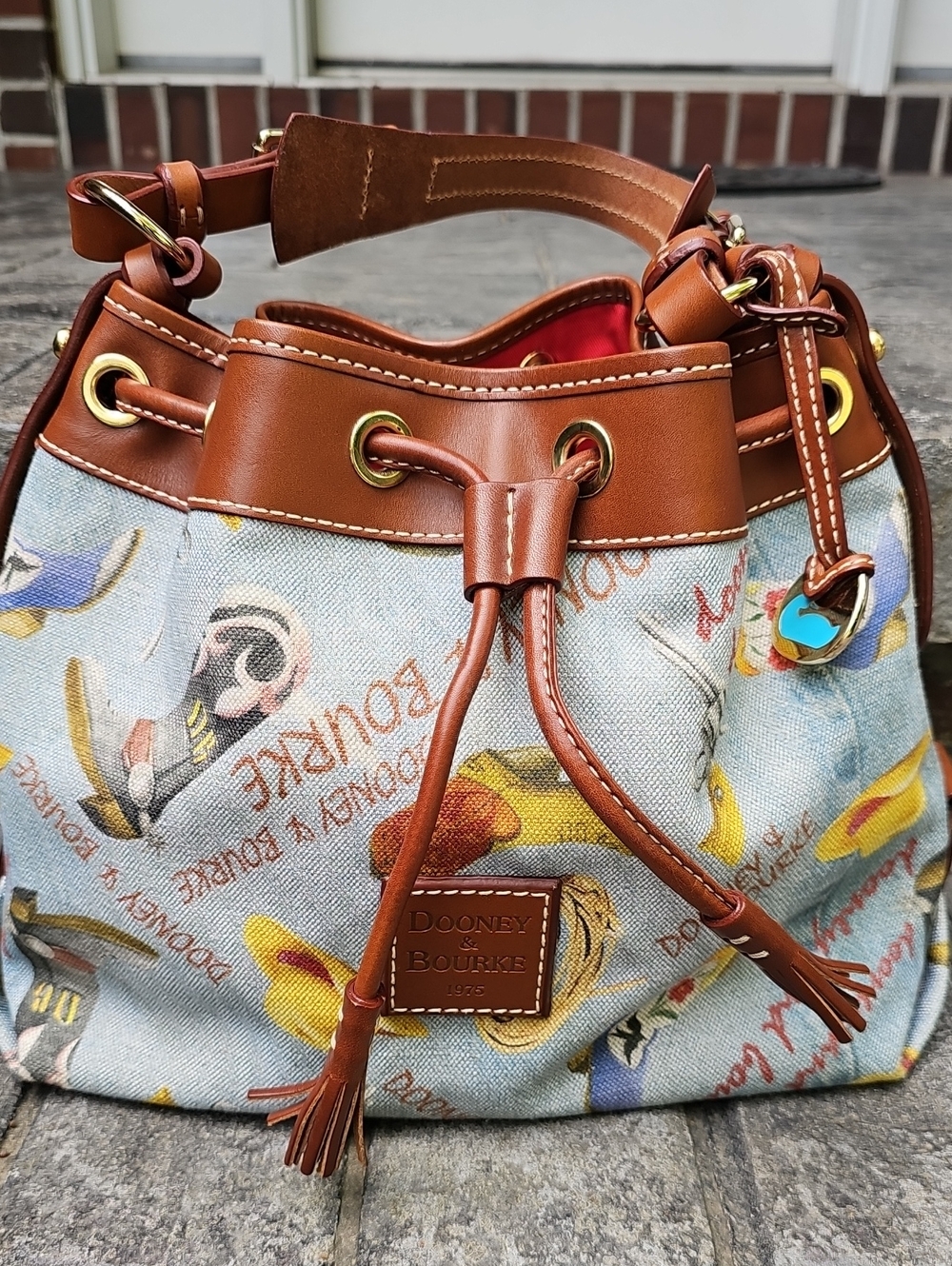 Dooney & Bourke Light Blue Printed Drawstring Satchel with Brown Trim - Picture 1 of 3